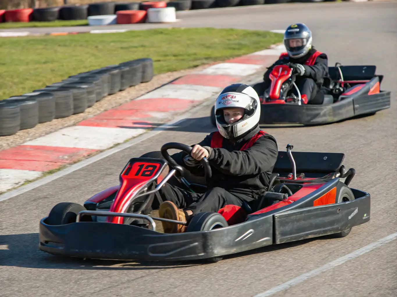 An image of a diverse group of adults participating in an advanced driving course, navigating a challenging track with precision and control, highlighting the advanced skills taught.